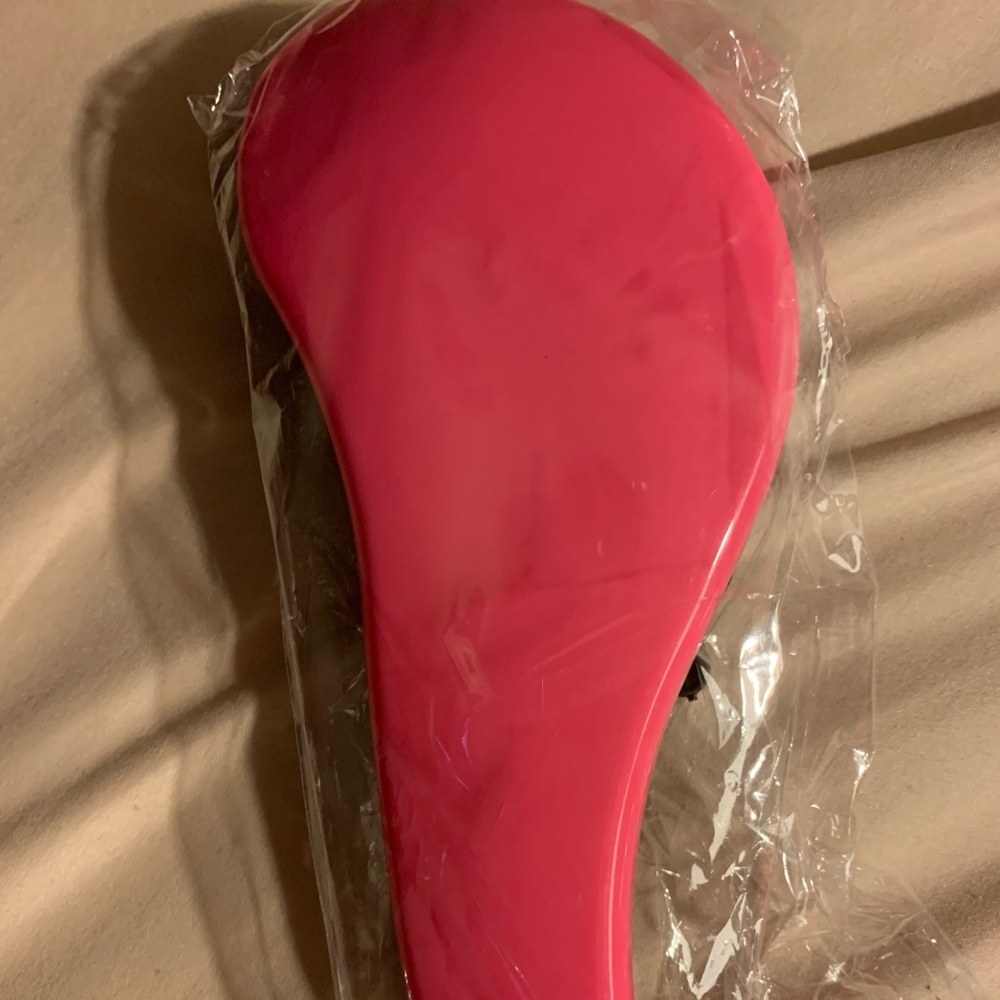 Pink hairbrush for damaged hair
